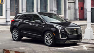 Stunning Cadillac Xt5 On Scenic Mountain Road Wallpaper