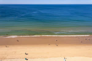 Stunning Coast Of Portuguese Beach During Sunset Wallpaper