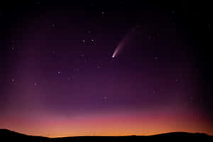 Stunning Comet Travelling Through The Star-studded Night Sky Wallpaper