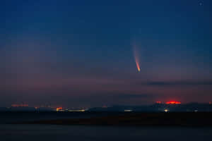 Stunning Cosmic Comet Illuminating The Night Sky Wallpaper