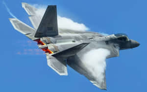 Stunning F-22 Raptor Military Jet Flying Over The Clouds Wallpaper