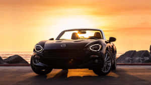 Stunning Fiat 124 Spider In Action Wallpaper