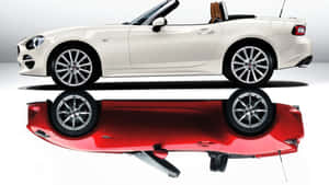 Stunning Fiat 124 Spider On A Scenic Road Wallpaper