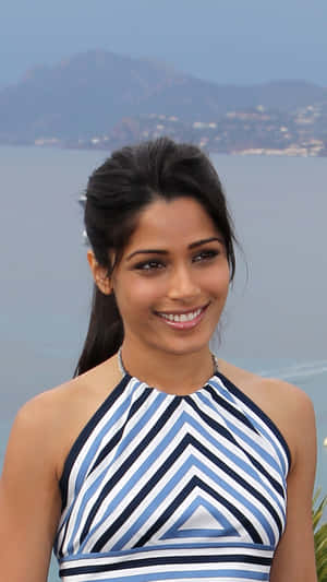 Stunning Freida Pinto In A Unique Pose Wallpaper