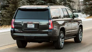 Stunning Gmc Yukon Driving Through A Picturesque Landscape Wallpaper