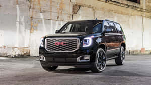 Stunning Gmc Yukon Gliding Down The Road Wallpaper