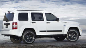 Stunning Jeep Liberty On A Picturesque Trail Wallpaper