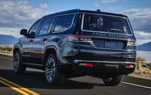 Stunning Jeep Wagoneer In Rugged Terrain Wallpaper