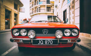 Stunning Lancia Driving Through A Forest= Wallpaper