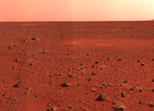 Stunning Mars Landscape Featuring Towering Cliffs And Rocky Terrain Wallpaper