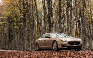 Stunning Maserati Ghibli On A Scenic Road Wallpaper