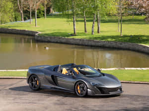 Stunning Mclaren 675lt Spider In A Vibrant Setting Wallpaper