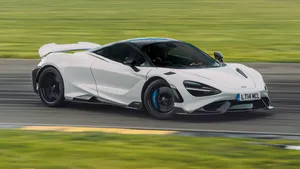 Stunning Mclaren 765lt Racing On The Track Wallpaper