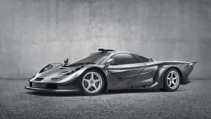 Stunning Mclaren F1 Speeding On The Road Wallpaper