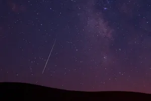 Stunning Meteor Shower In Night Sky Wallpaper