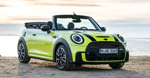 Stunning Mini Cooper Convertible Cruising Through Vibrant City Streets. Wallpaper