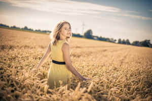 Stunning Model In A Vibrant Yellow Dress Wallpaper