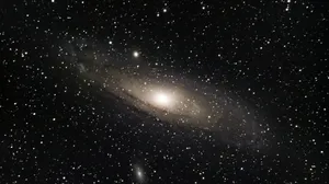 Stunning Nature Scene Of Rolling Green Hills With A River In The Background Wallpaper