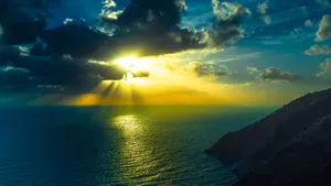 Stunning Ocean View During A Vibrant Sunset Wallpaper