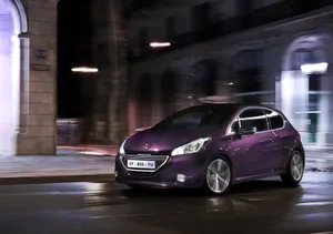 Stunning Peugeot 208 Vehicle Accelerating On A Scenic Highway Wallpaper