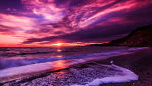 Stunning Purple Sunset With Serene Landscape Wallpaper