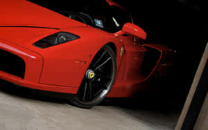 Stunning Red Ferrari Enzo On A Picturesque Road Wallpaper