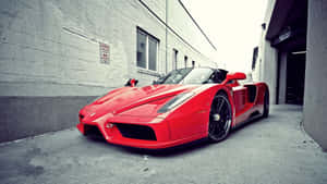 Stunning Red Ferrari Enzo On Open Road Wallpaper