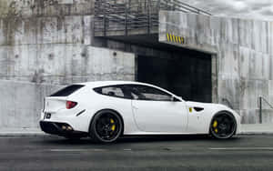 Stunning Red Ferrari Ff On A Picturesque Landscape Wallpaper