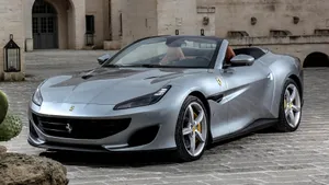 Stunning Red Ferrari Portofino Cruising On The Open Road Wallpaper