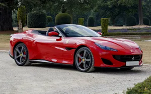 Stunning Red Ferrari Portofino Cruising On The Road Wallpaper
