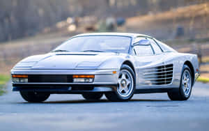 Stunning Red Ferrari Testarossa On Open Road Wallpaper