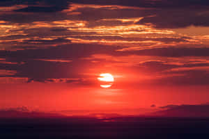 Stunning Red Sunset Over The Horizon Wallpaper