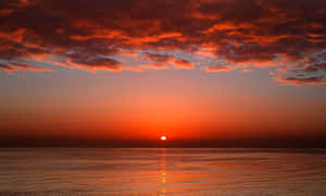 Stunning Red Sunset Over The Horizon Wallpaper