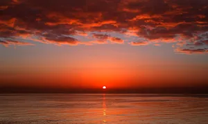 Stunning Red Sunset Over The Horizon Wallpaper