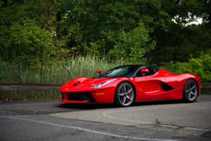 Stunning Shot Of A Red Ferrari Laferrari In Motion Wallpaper