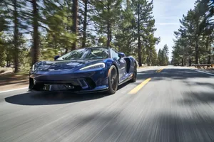 Stunning Silver Mclaren Gt On The Road Wallpaper