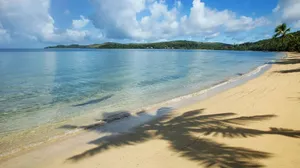 Stunning Sunset At A Serene Fiji Beach Wallpaper
