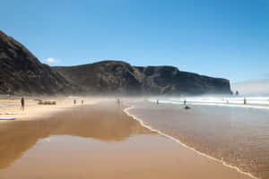 Stunning Sunset At A Tranquil Portuguese Beach Wallpaper