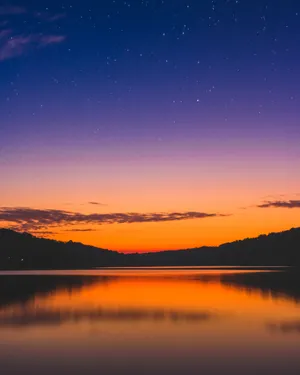 Stunning Sunset Hues Over Tranquil Waters Wallpaper