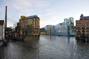 Stunning Sunset Over Norrköping's Iconic Industrial Landscape Wallpaper