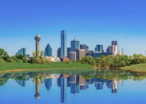 Stunning View Of Dallas Illuminated Skyline At Night Wallpaper
