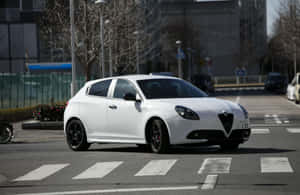 Stylish Alfa Romeo Giulietta On The Road Wallpaper