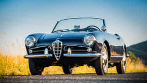 Stylish Alfa Romeo Spider Cruising On An Open Road Wallpaper