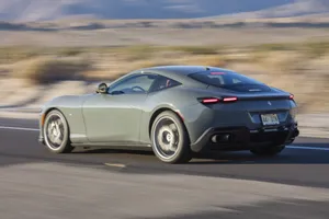 Stylish And Elegant, The Ferrari Roma On The Open Road Wallpaper