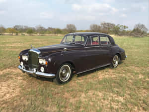 Stylish And Luxurious Bentley S3 On The Open Road Wallpaper