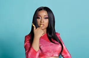 Stylish Artistin Red Topand Bold Makeup Wallpaper