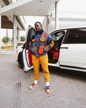 Stylish Athlete Exiting Vehicle Wallpaper