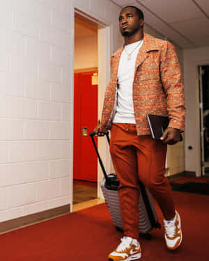 Stylish Athlete Walkingwith Luggage Wallpaper