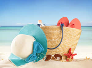 Stylish Beach Bag And Accessories On The Sand Wallpaper