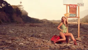 Stylish Beach Bag Essentials On The Sandy Shore Wallpaper